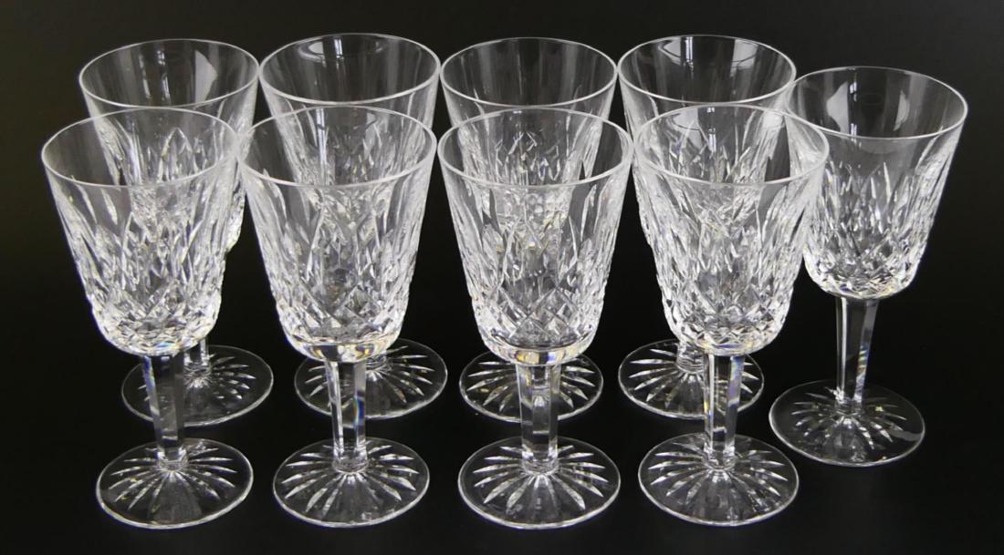 9 WATERFORD "LISMORE" CRYSTAL WHITE WINE GLASSES: A set of 9 Waterford Irish cut crystal white wine stemware cups in the "Lismore" pattern. Each with acid watermark to bottoms. Glasses measures approx. 5 1/2" height x 2 5/8" diameter at rim (14cm x 6