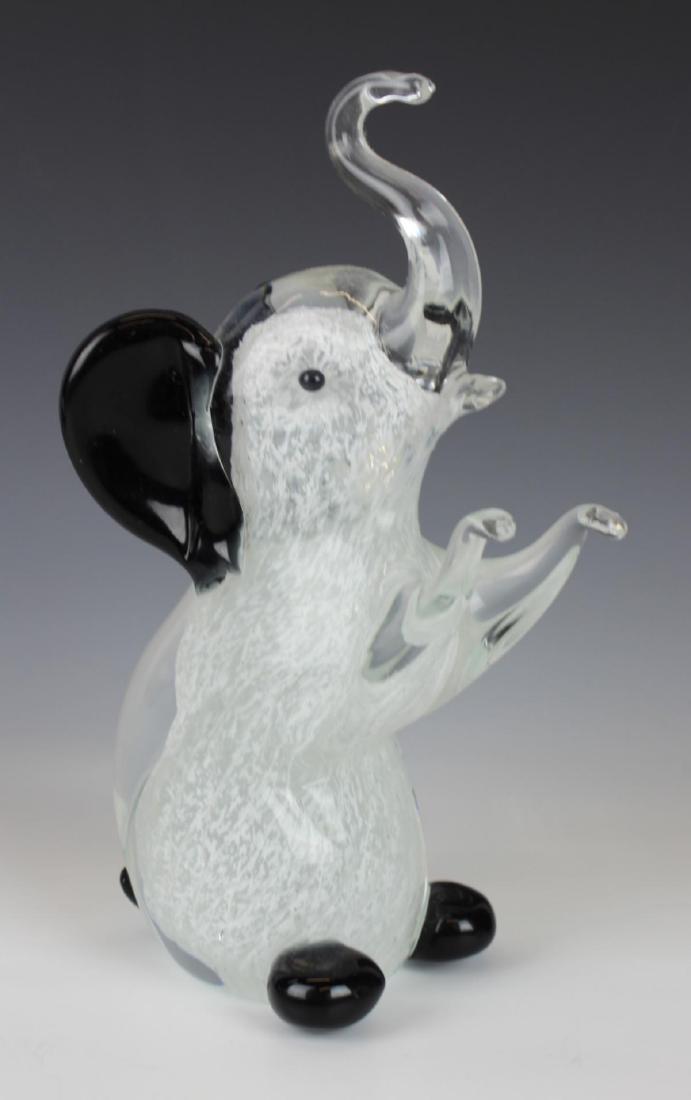 MURANO MILK & ONYX GLASS SEATED ELEPHANT FIGURE: Murano hand blown Italian art glass elephant crafted of clear glass with milk flecking and onyx ears, eyes and feet. Measures approx. 8 3/8" height (21.3cm).