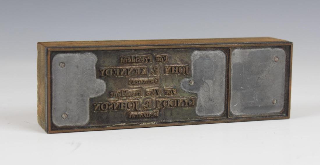 PRESIDENT KENNEDY & VP JOHNSON PRESIDENTIAL SEAL: A Presidential pointing plate seal for President John F. Kennedy and Vice President Lyndon B. Johnson. Crafted of wood and metal. Measures approx. 4 1/2" length x 1 1/2" width x 7/8" height (11.4cm x 