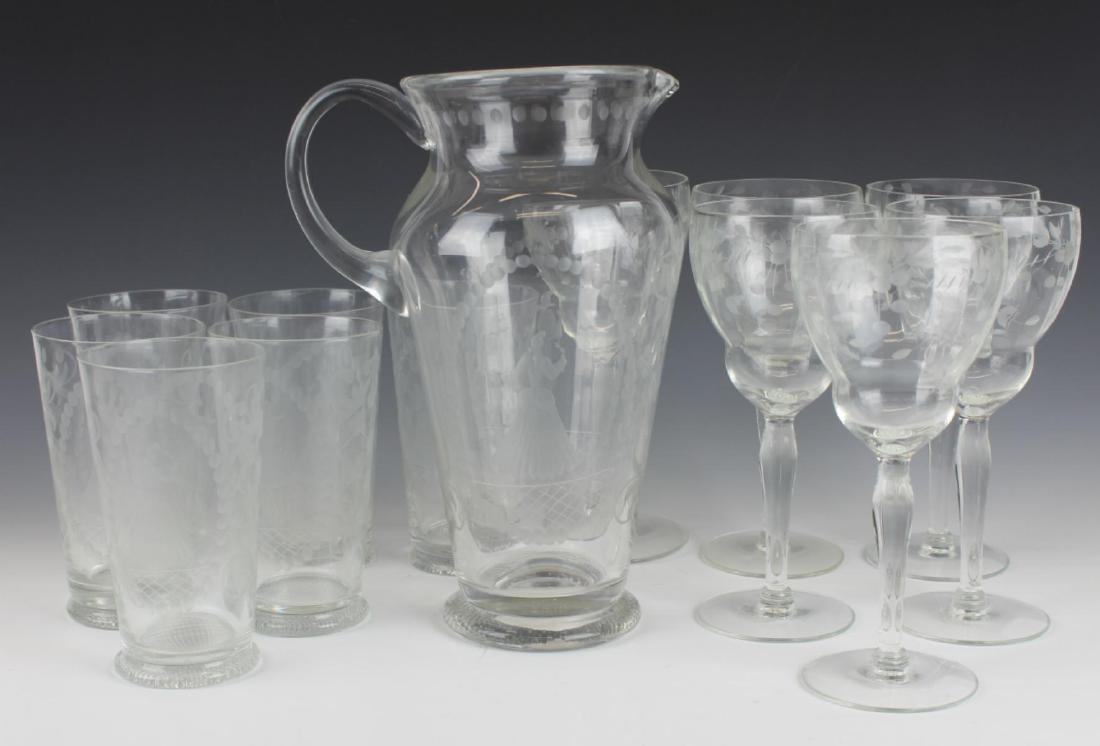 (13) ANTIQUE ETCHED WINE & WATER GLASS & PITCHER: 13 pc Antique glass water (5 1/4" H) and wine glasses(7 3/4" H) with a large pitcher (10 1/4" H).
