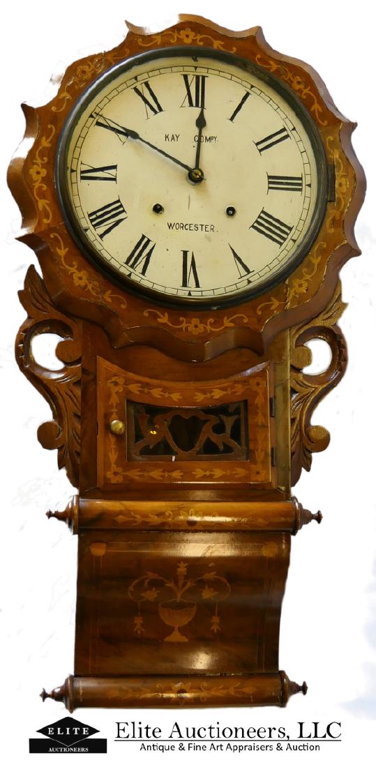KAY COMPANY WORCESTER MARQUETRY WALLL CLOCK: A large Kay Company, Worcester marquetry inlaid wooden case wall clock. Measures approx. 32" height x 17" width x 5" depth (81.3cm x 43.2cm x 12.7cm).