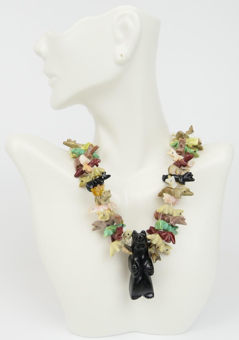 DAVID SAITY NATIVE AMERICAN CARVED DOG NECKLACE: Measures 30" long, with numerous carved dogs, out of natural stones, turquoise, coral etc with large onyx stone in middle. David Saity, who made his Manhattan jewelry store famous for selling the bigg