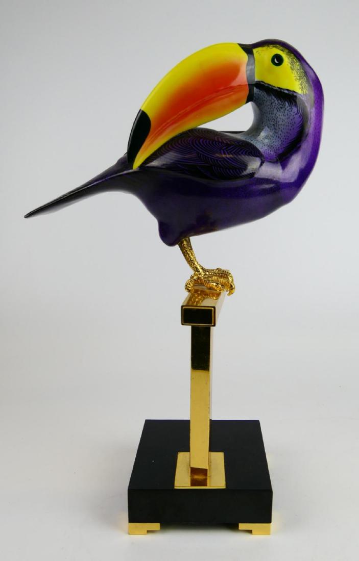 OGGETTI POLYCRHOME METAL PERCHED TOUCAN SCULPTURE: An Oggetti polychrome enameled metal perched toucan bird sculpture on a black acrylic base. Retains labels under tail. Measures approx. 15" height (38.1cm).