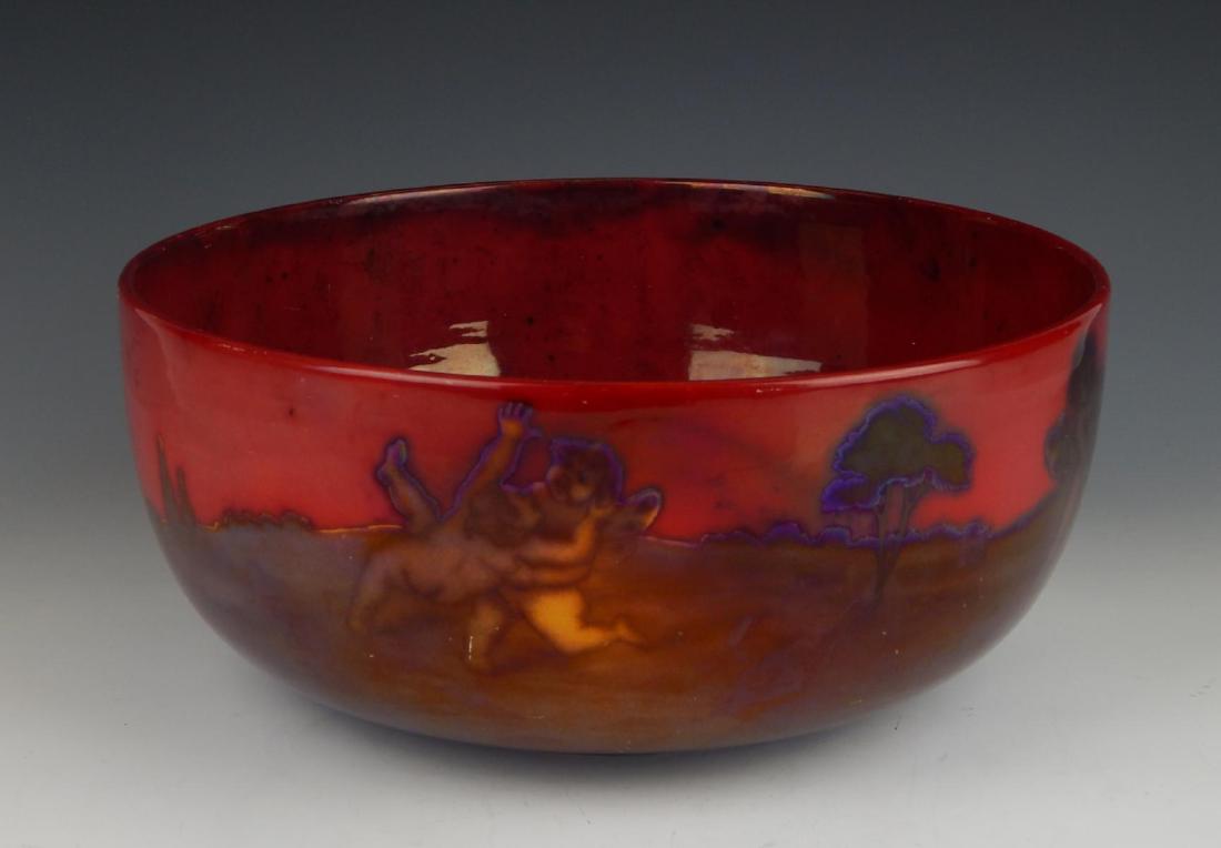 1900's ZSOLNAY PECS LUSTER EOSIN GLAZE CENTER BOWL: Antique Zsolnay Pecs Hungarian red original Eosin glazed luster ware pottery bowl depicting winged cherubs in landscape scene to exterior and interior features men with nude females, cherub and horse.