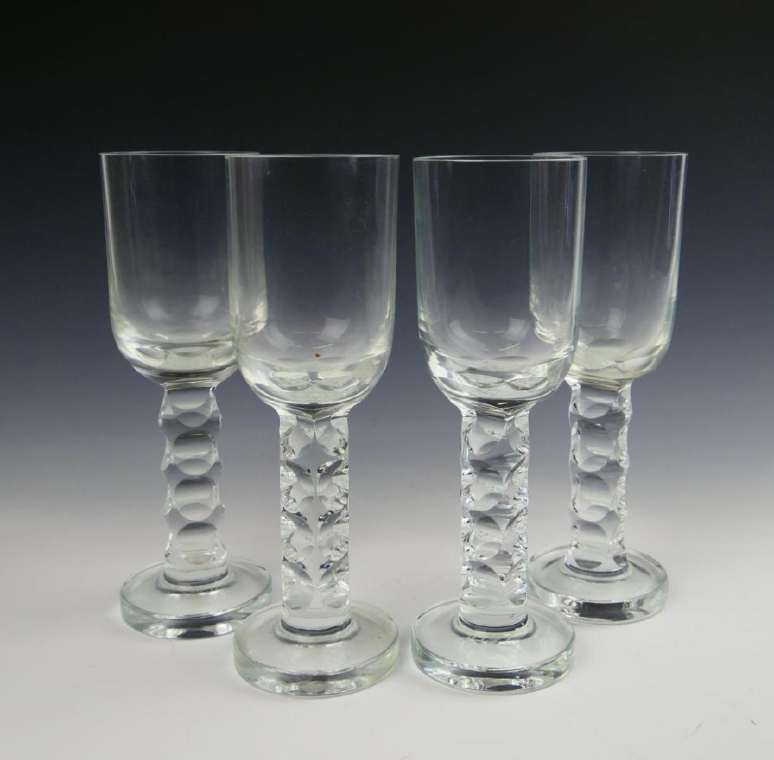 4 MOSER GLASS MODERN STYLE WINE STEM GLASSES: A set of 4 Moser glass wine / champagne stem glasses having a Modernist style with round cuts to stem. Acid hallmark to bottoms. Glasses measures approx. 8 1/4" height x 2 3/4" diameter (21cm x 6.9cm)