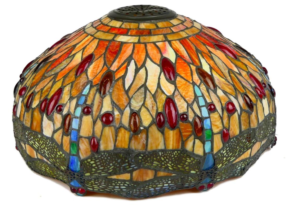 TIFFANY STYLE DRAGONFLIES SLAG GLASS LAMP SHADE: A Tiffany Studios, New York style round slag glass lamp having a dragonfly design and further jeweled with glass jewels. Measures approx. 9 1/2" height x 17" diameter (24.1cm x 43.1cm).