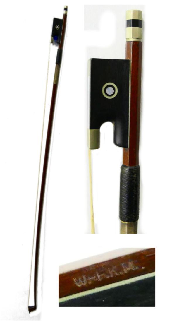WFKM GERMAN NICKEL MOUNTED MOP INLAY VIOLIN BOW: A fantastic W. F. K. M. German violing bow crafted of wood and ebony featuring nickel mounting and mother of pearl inlay. Marked "W.F.K.M." Measures approx. 29 1/4" length (74.3cm).