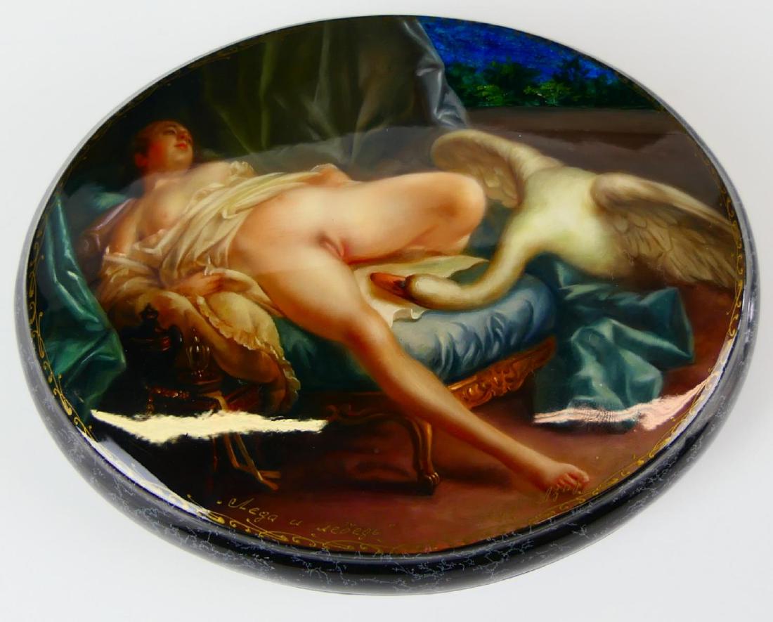 RUSSIAN LACQUER "LEDA & THE SWAN" EROTIC BOX: A Russian lacquer hinged covered erotic box of oval form depicting "Leda and the Swan". Signed to lower left of cover. Has a red interior. Measures approx. 5 1/4" height x 4 1/4" width x 1 1/2" height