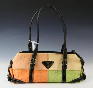 PRADA MULTI-COLOR OSTRICH LEATHER PURSE: A Prada mutli-color ostrich leather purse. Has black silk interior with one zippered and open pocket. Adjustable buckle black leather straps. Bag measures approx. 5" height x 13" width x 4" depth (12.