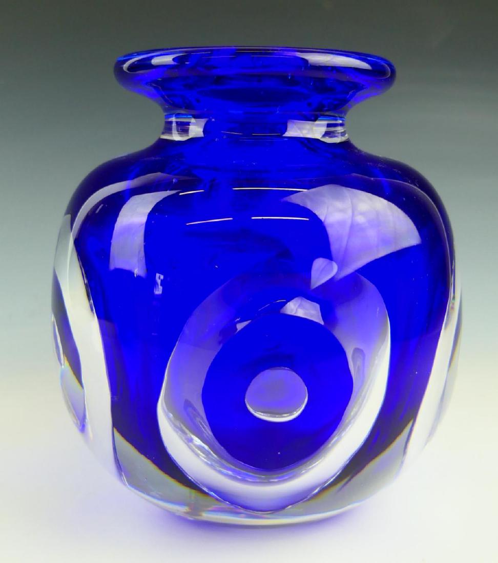 HEAVY ORREFORS COBALT TO CLEAR GLASS VASE: A very heavy Orrefor's Swedish hand blown glass vase having a cobalt blue to clear design with circles. Etched signature to bottom. Measures approx. 6 3/4" height x 61/2" diameter (17.1cm x 16.5cm).