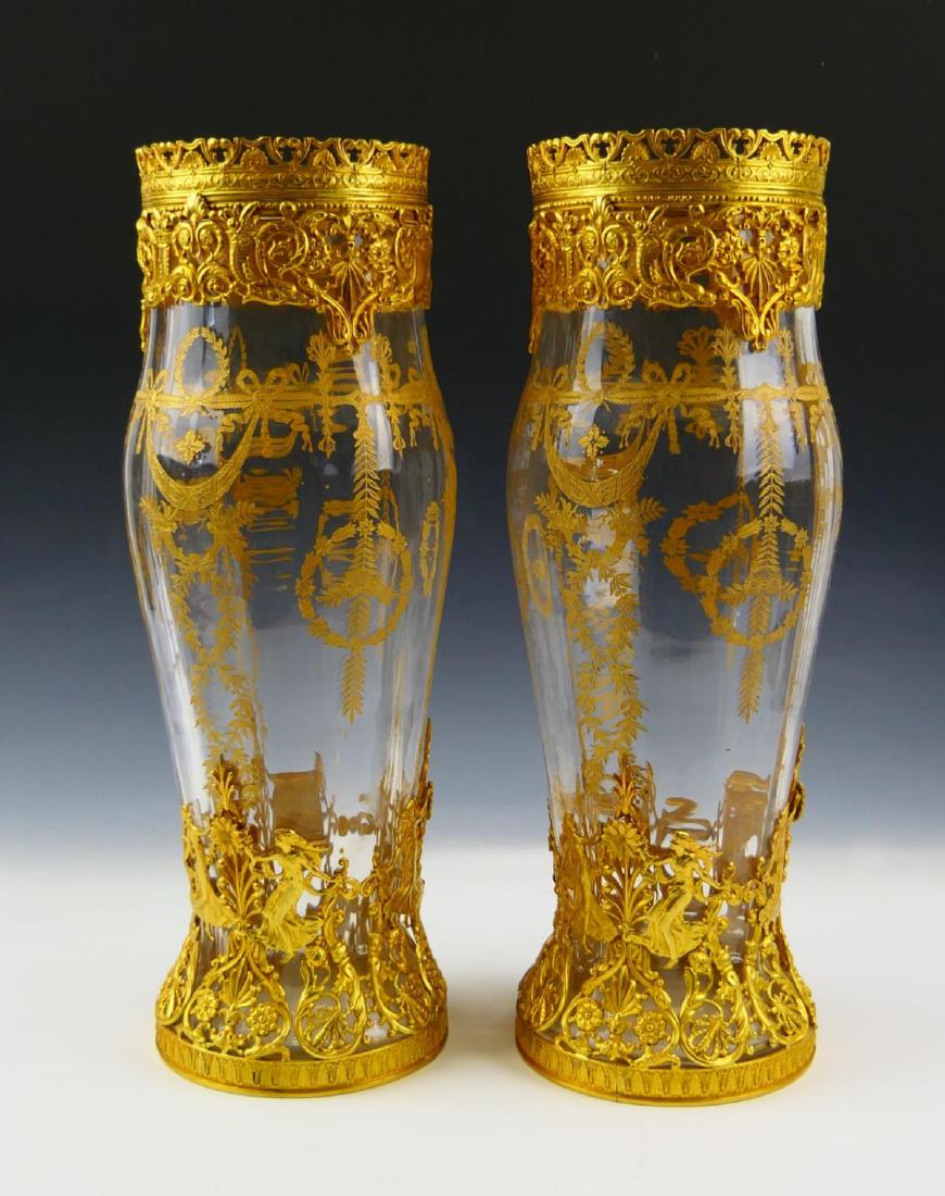 Pr UNSIGNED BACCARAT CRYSTAL DORE MOUNTED VASES: A pair of lovely unsigned Baccarat French clear crystal vases mounted with ormolu gold gilt bronze having a floral leaf design. Measures 13" height (33cm).