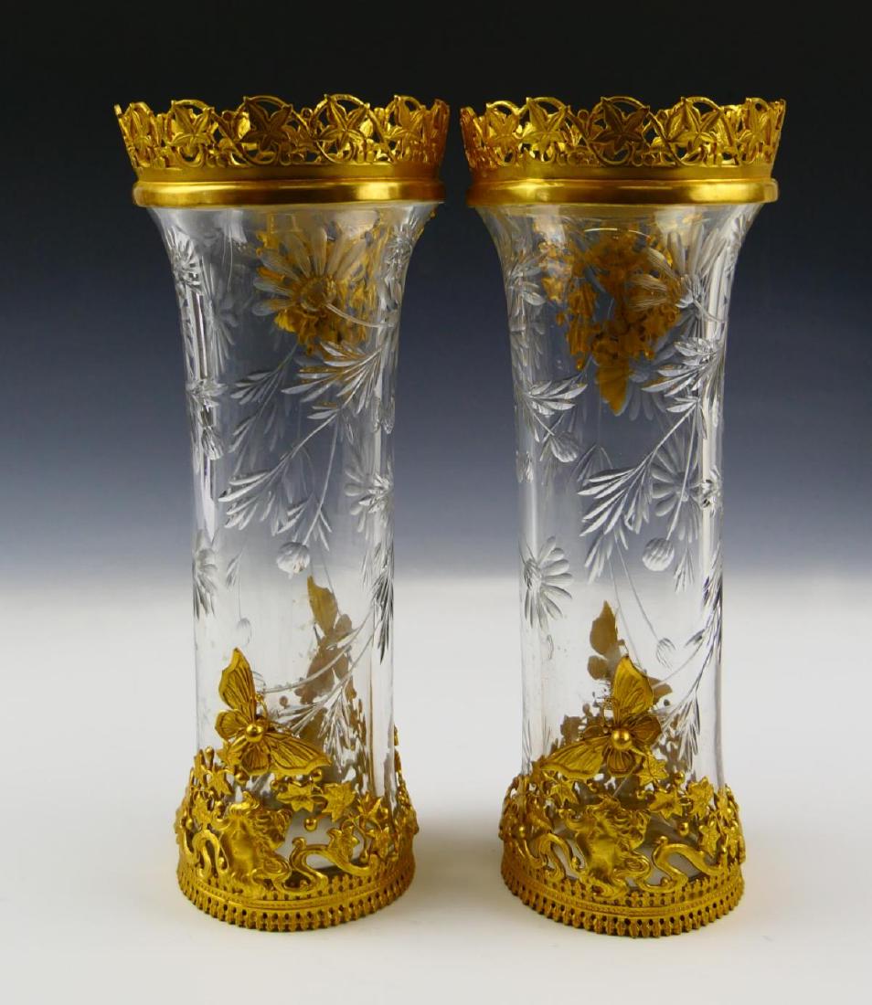 Pr UNSIGNED BACCARAT CRYSTAL DORE MOUNTED VASES: A pair of unsigned Baccarat French cut crystal vases with floral designs. Each mounted with ormolu gold gilt bronze work with scrolled vines and butterflies. Measures 9" height (22.8cm).
