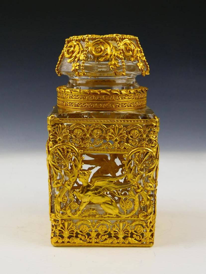 UNSIGNED BACCARAT CRYSTAL DORE MOUNTED JAR: Wonderful unsigned Baccarat French clear crystal jar with stopper mounted with ormolu gold gilt bronze having a griffon design with intricate scroll work. Measures approx. 7" height (17.8cm).
