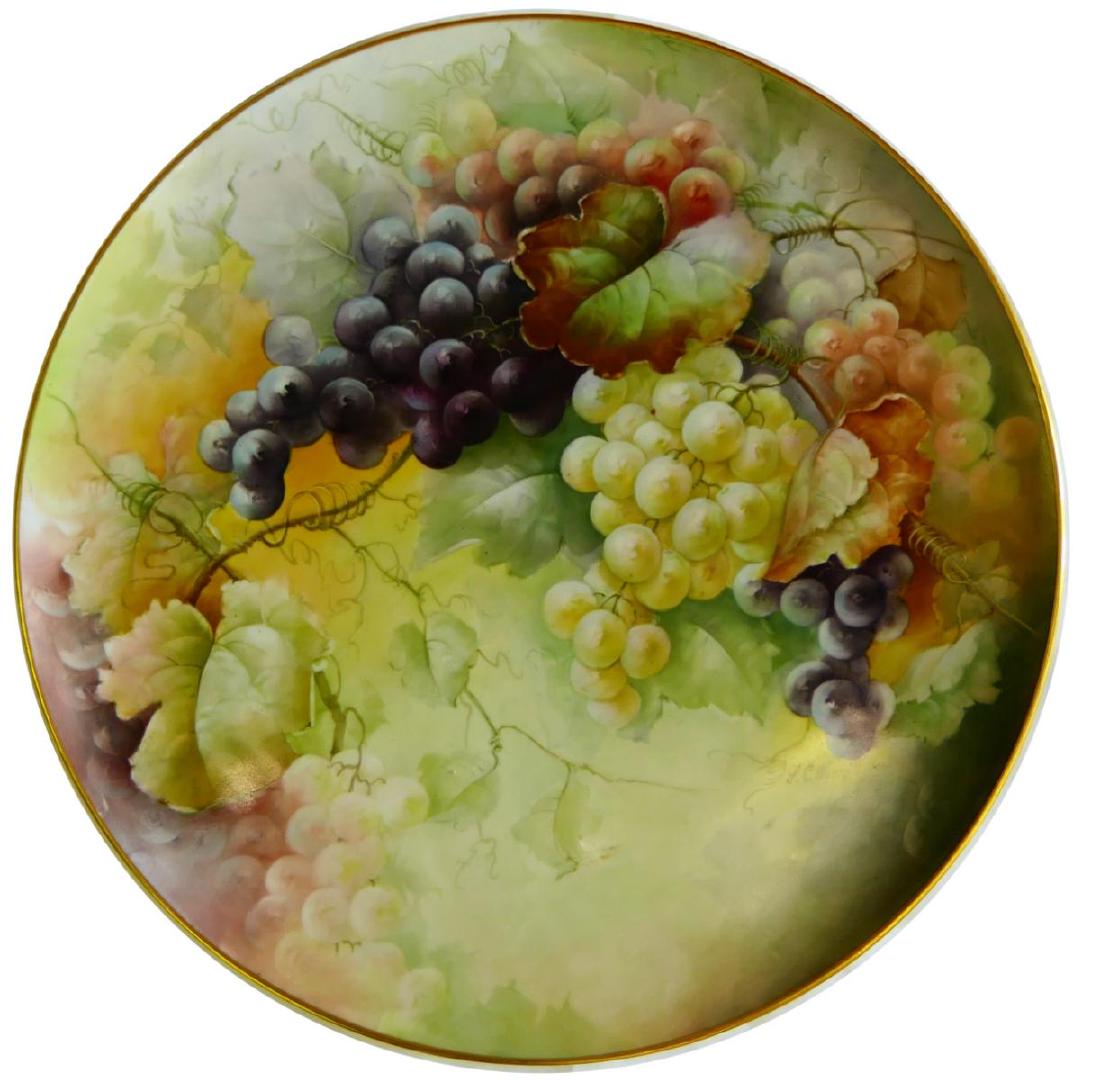 T&V LIMOGES GRAPES 16" CHARGER SIGNED WORRELL: Antique Tressemann and Vogt Limoges French porcelain round charger having a grape clusters design. Signed "L. C. Worrell". Measures 16" diameter (40.6cm).