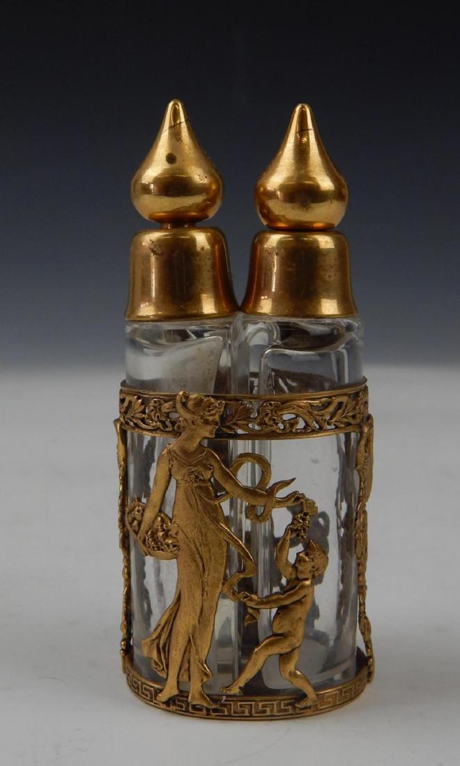 ANTIQUE FRENCH GLASS DORE MOUNTED DOUBLE SCENT: 19th century Paris school clear glass double perfume scent bottle with stoppers mounted with gold gilt ormolu bronze. Measures approx. 4" height (10.2cm).