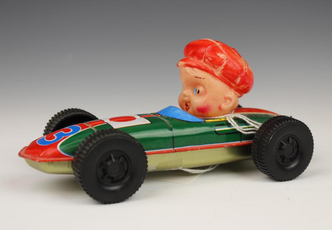 VINTAGE TIN RACE CAR DRIVER TOY: Vintage tin race car driver toy. Measures 6 3/4" length.