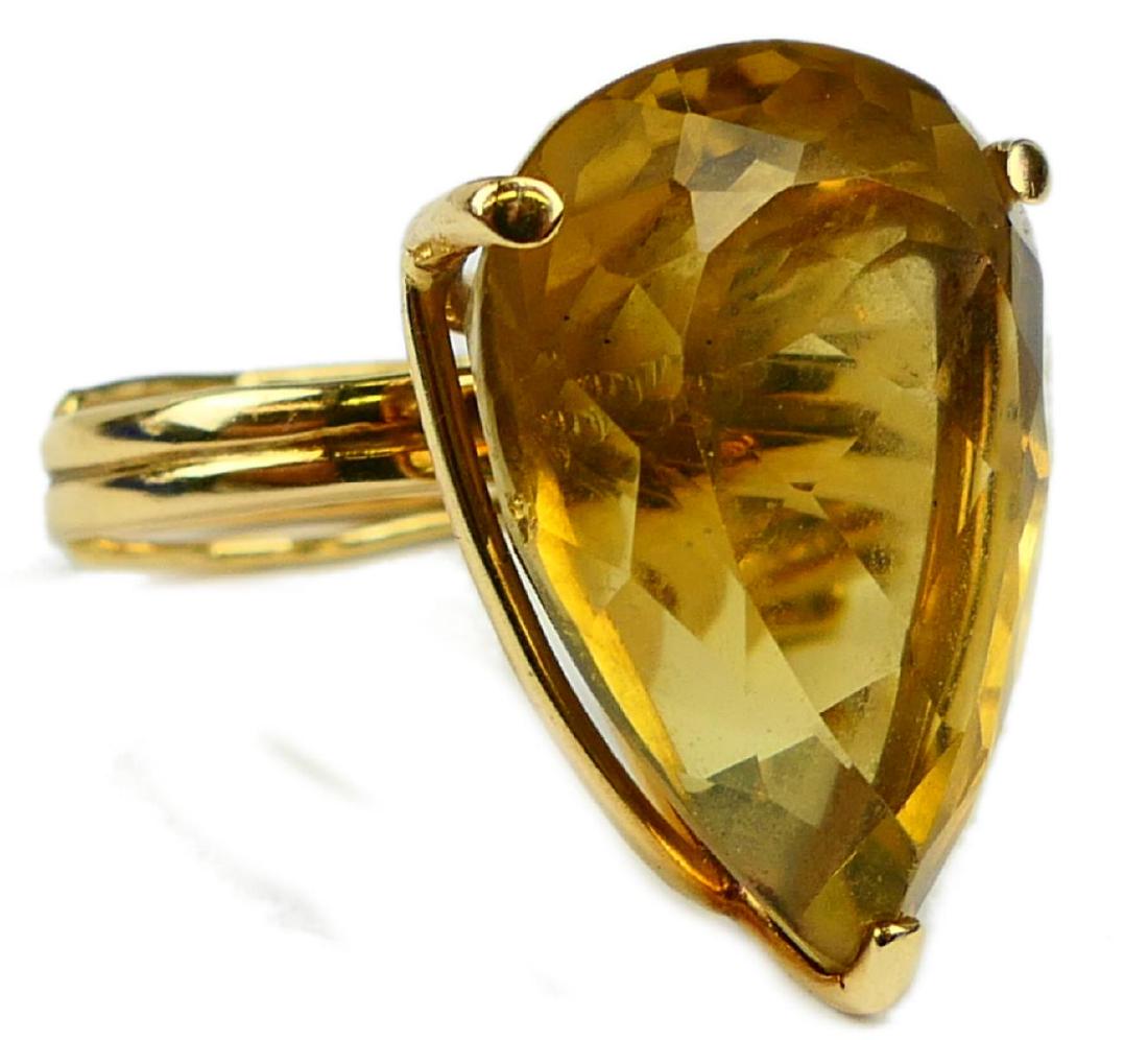 14K YG 52CT PEAR YELLOW TOPAZ SOLITAIRE RING: Stunning women's estate solitaire ring crafted of 14k yellow gold featuring a pear cut yellow topaz gemstone approx. 25mm x 20mm x 15mm; approx. 52.00ct. Mounting and band having a wire frame design. 