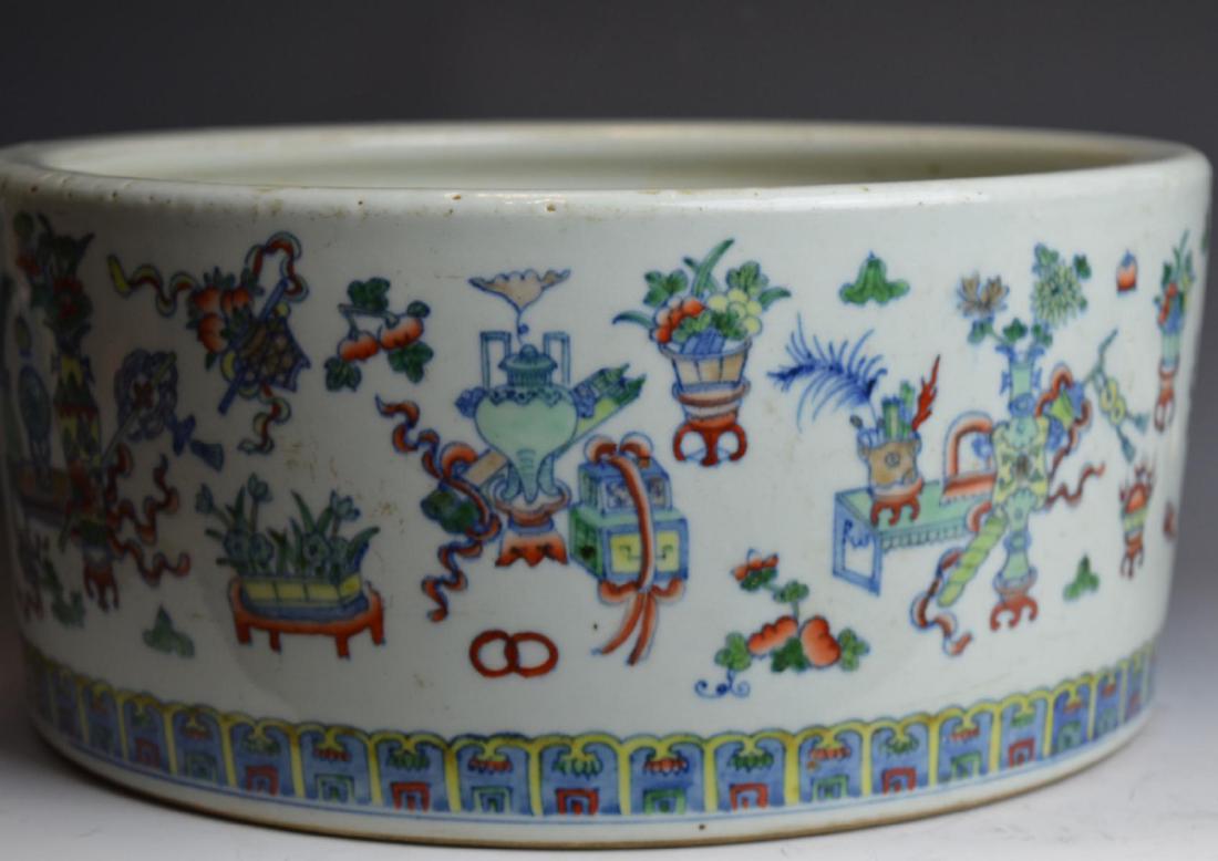 LARGE CHINESE DOUCAI PORCELAIN FLORAL FISH POT: Chinese hand painted Doucai porcelain round fish pot having a design depicting flowers and plants emerging from vases. Bottom holds blue six character zhuanshu Qianlong reign mark. Measures approx. 13