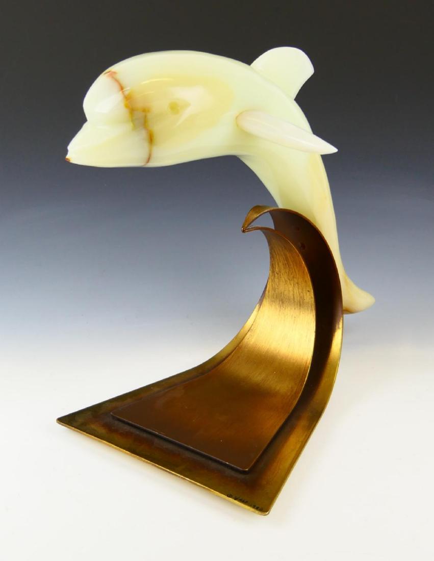CURTIS JERE 1980 METAL & WHITE ONYX DOLPHIN: Curtis Jere (AMERICAN / CALIFORNIA / CHINA, 1910 - 2008) mixed media sculpture featuring a carved white onyx stone dolphin mounted to a metal base stylized as a curling wave. Signed to base and dated