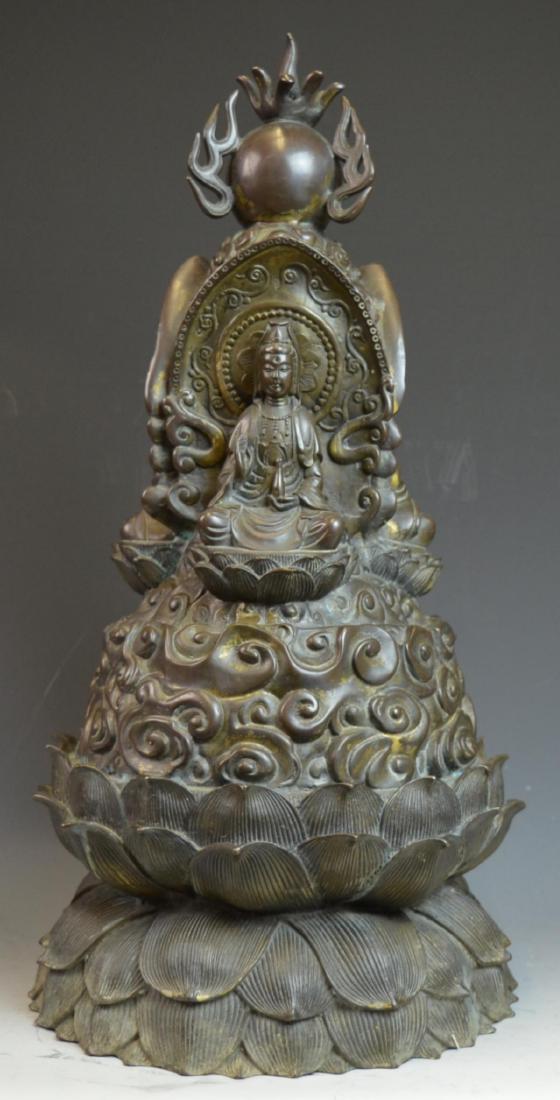 CHINESE BRONZE SEATED CROWNED BUDDHA SCULPTURE: Impressive Chinese bronze sculpture depicting Buddha seated with crown on lotus leaf throne lofted by stylized clouds. A flaming pearl can be seen above his head. Measures approx. 22" height x 11" wid