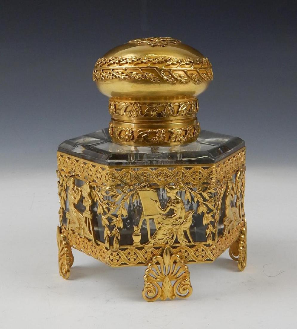 UNSIGNED BACCARAT CRYSTAL DORE MOUNTED INKWELL: Unsigned Baccarat clear crystal inkwell mounted with gold gilt ormolu bronze depicting a woman painted and leaves with intricate patterns. Measures 6" height (15.2cm).