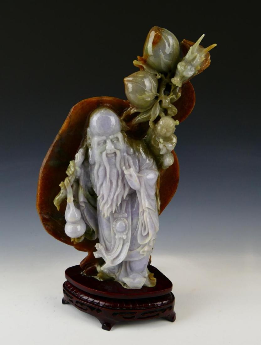 HEAVY CHINESE TRI TONE JADE SHOU-XING SCULPTURE: A large and heavy Chinese carved sculpture depicting the Lucky Star God of old age Shouxing. Jade has white, celadon and russet tones seen. Includes fitted wooden stand. Measures approx. 11 7/8" heigh