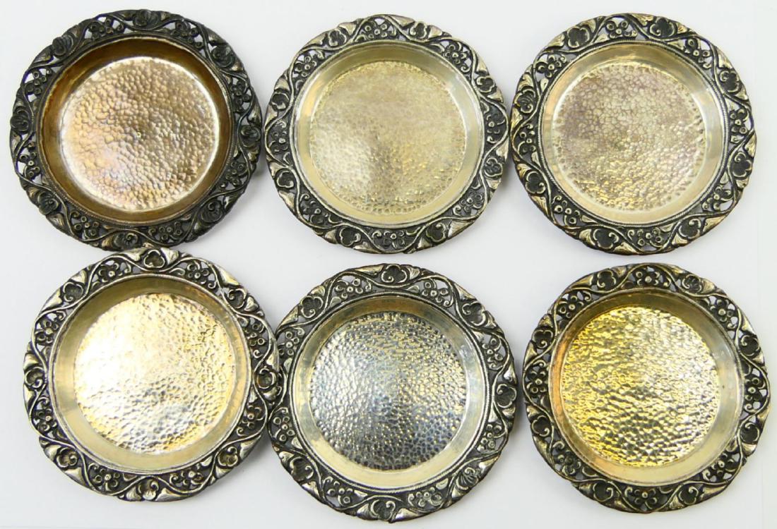 6 INDONESIAN 800 SILVER DEMITASSE SAUCERS: 12 piece set of 800 Indonesian silver demitasse saucers having a reticulated floral design to rim with hand hammered center. Each marked 800. Measures approx. 3 5/8" diameter (9.2cm). Total weight app