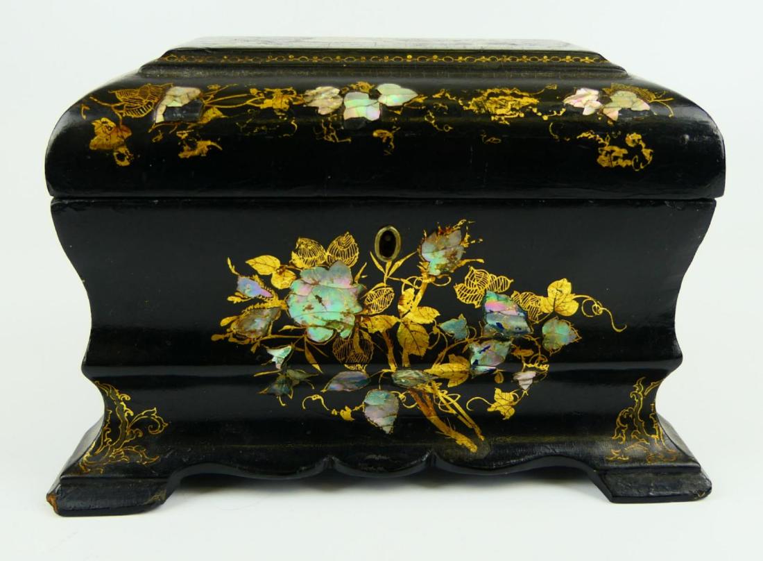 CONTINENTAL WOOD MOP INLAY TEA CADDY CASKET: Antique Continental mother of pearl inlaid wooden tea caddy casket. Has hinged cover with floral design and hand painted gold flowers. Measures approx. 5 3/4" height x 8 3/4" width x 5 3/4" depth (14.