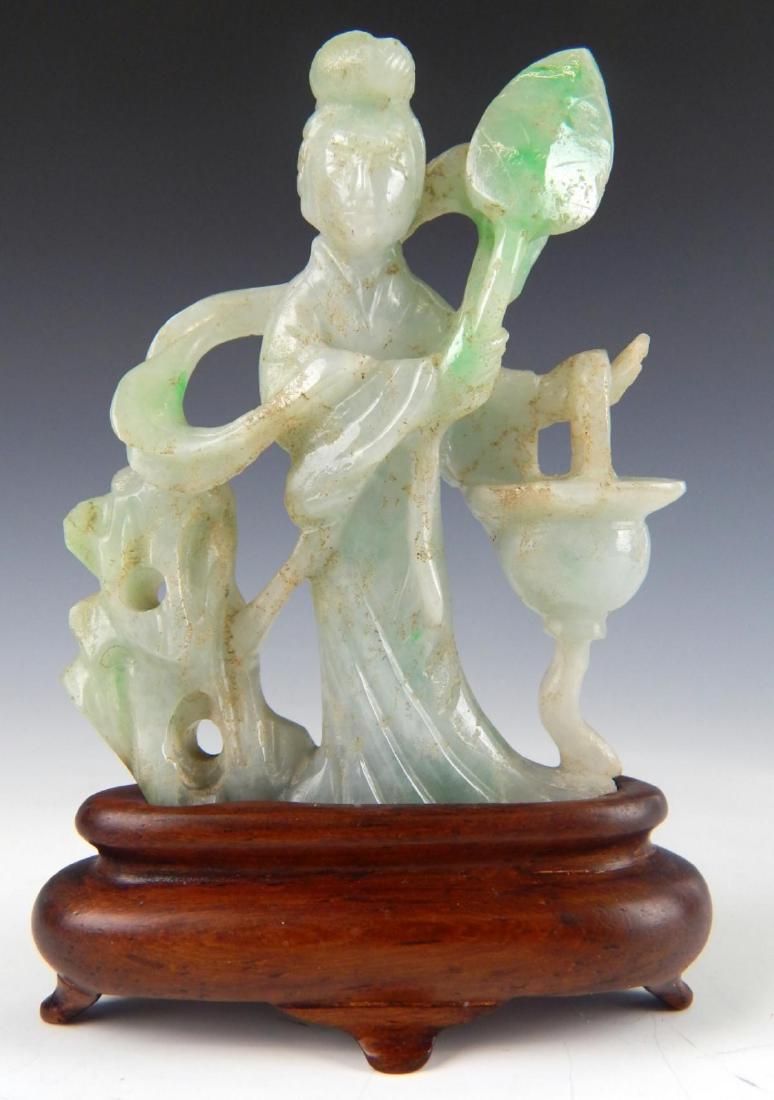 CHINESE GREEN & WHITE JADEITE QUAN YIN SCULPTURE: A vintage, possibly antique Chinese hand carved jadeite jade sculpture depicting a standing Guan Yin holding leaf and planter with a rock formation to her left. Includes fitted wooden base. Jade with 