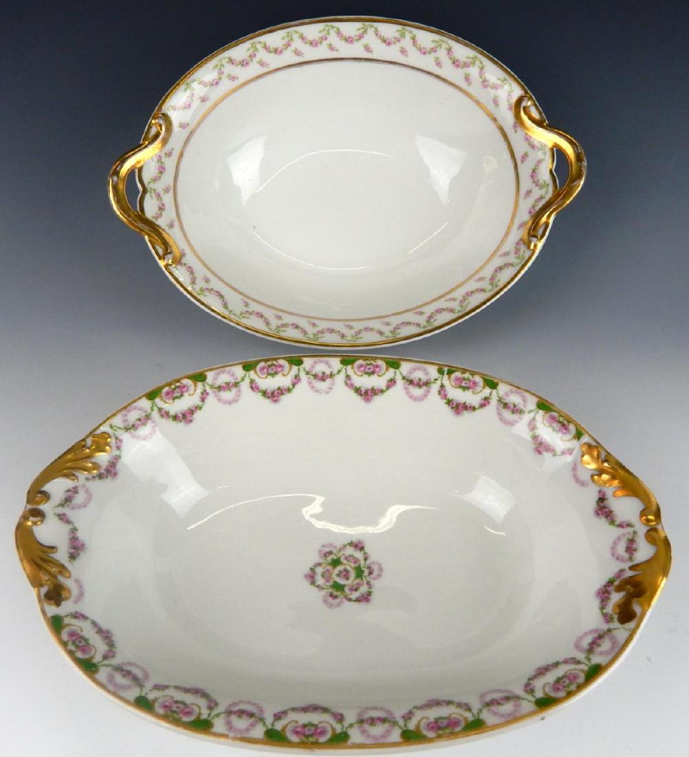 2 ANTIQUE LIMOGES PORCELAIN OVAL SERVING BOWLS: A lot of 2 antique Limoges French hand painted porcelain oval handled serving bowls with floral designs. One with GDA and Charles Haviland stamp marks; the other holds PL and M. Redon stamp marks. Eac