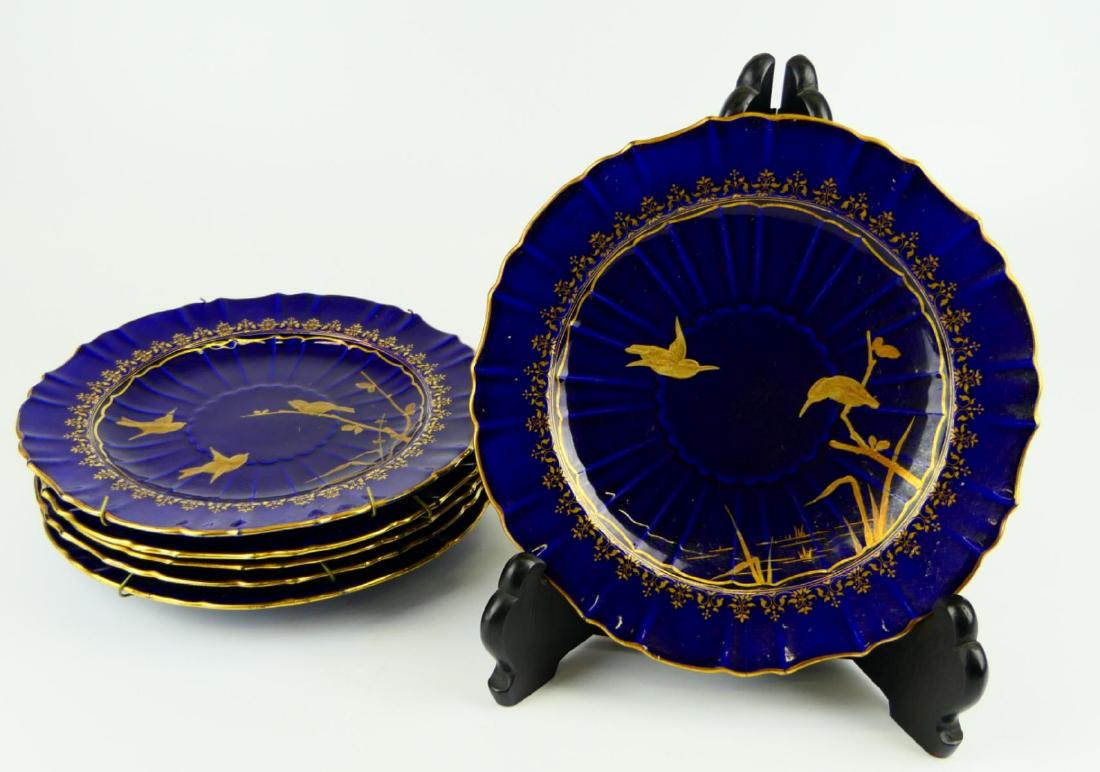 6 ANTIQUE MINTON COBALT BLUE & GOLD BIRD PLATES: A set of 6 antique Minton English porcelain scalloped rim plates haivng hand painted gold birds designs over a cobalt blue ground. Each with impressed marks to bottom. Each measures approx. 9" diamete