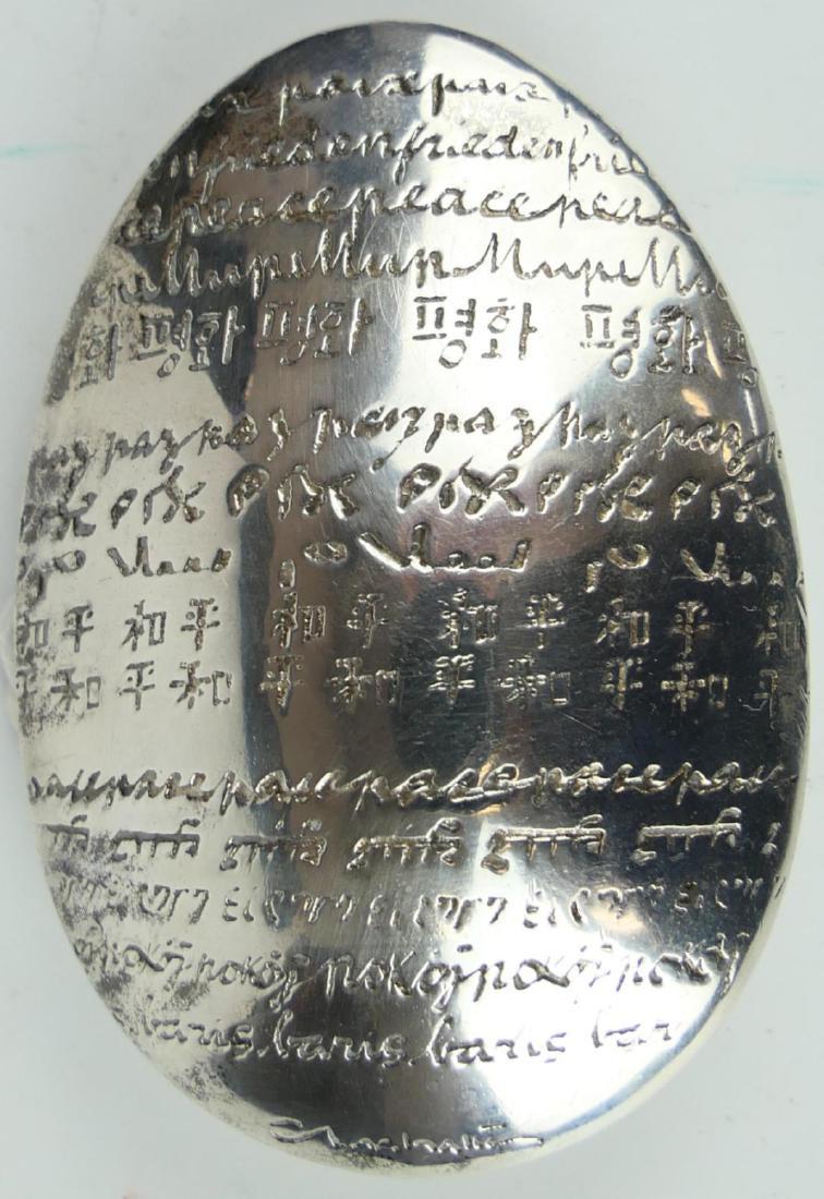 CHRISTOFLE PAIX SILVER PLATED PEACE PAPERWEIGHT: CHRISTOFLE PAIX SILVER PLATED PEACE PAPERWEIGHT, MEASURES 3 1/2" LENGTH.