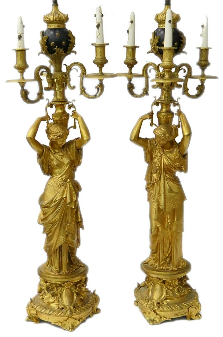 Pr IMPRESSIVE 4 FOOT FIGURAL DORE BRONZE CANDELABRA: A pair of large and breathtaking antique French Empire figural dore bronze figural three arm candelabra having a Roman Revival design depicting women draped in layered robe holding urns standing atop