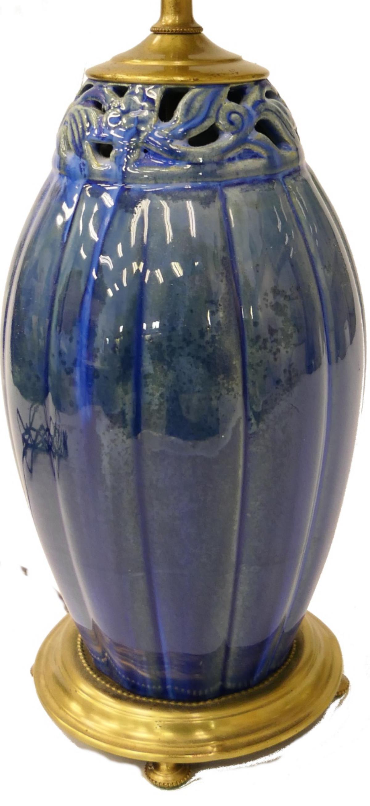 ANTIQUE AMPHORA TABLE LAMP: Made into a lamp sometime mid century. The Amphora vase insert is of a molten blue reticulated top. The vase measures 10 1/2" tall. Lamp to the top of the socket measures about 16" plus hoop. Very goo