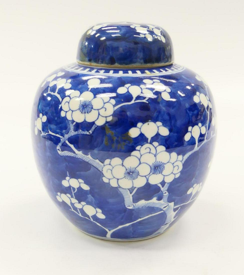 VINTAGE CHINESE BLUE & WHITE PORCELAIN GINGER JAR: Vintage Chinese hand painted blue and white porcelain ginger jar covered vase having a peony floral blooms on branches design. Bottom holding double blue circles mark. Measures approx. 7 5/8" height x