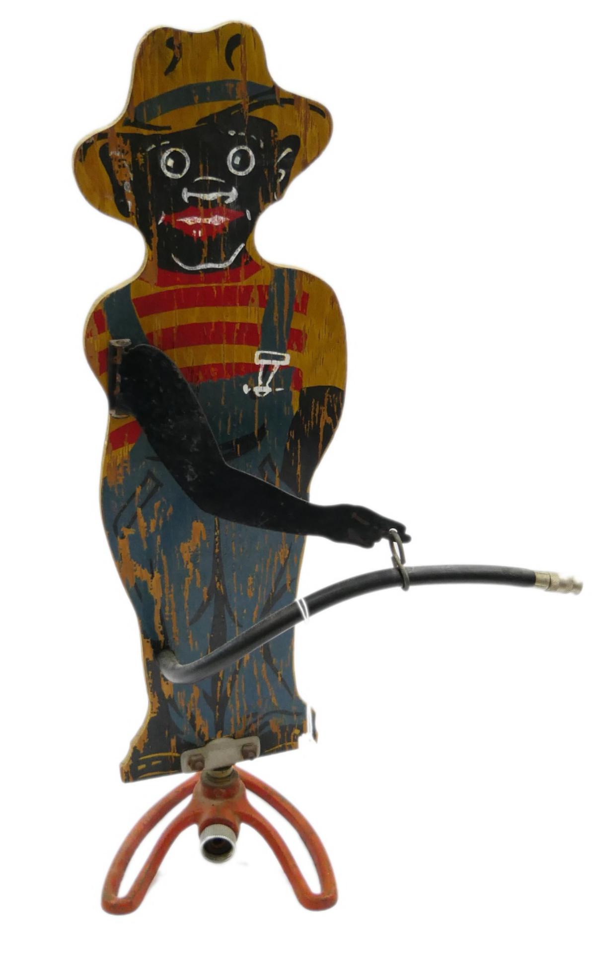 ORIGINAL BLACK AMERICANA "SPRINKLIN SAM" SPRINKLER: An original Black Americana "Sprinklin' Sambo" oscillating lawn sprinkler. Measures approx. 27" height (68.6cm).