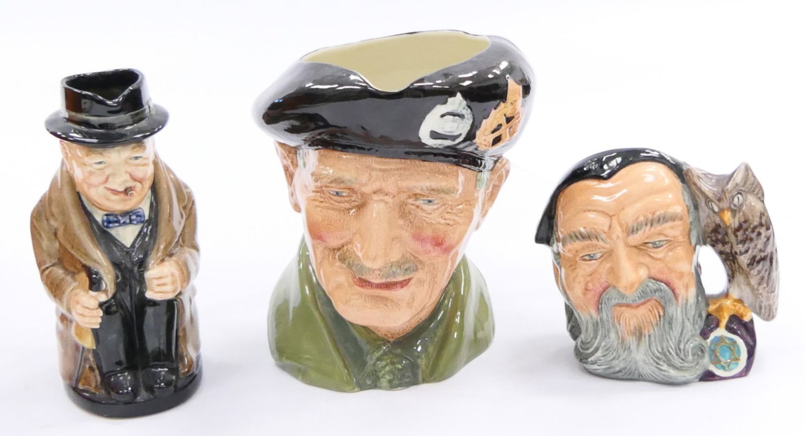LOT OF 3 ROYAL DOULTON CHARACTER TOBY JUGS / MUGS: A lot of three Royal Doulton English porcelain character Toby Jugs to include "Merlin" D6536, "Winston Churchill" 8360A and "Monty" D6202. Tallest approx. 5 1/2" height (14cm).