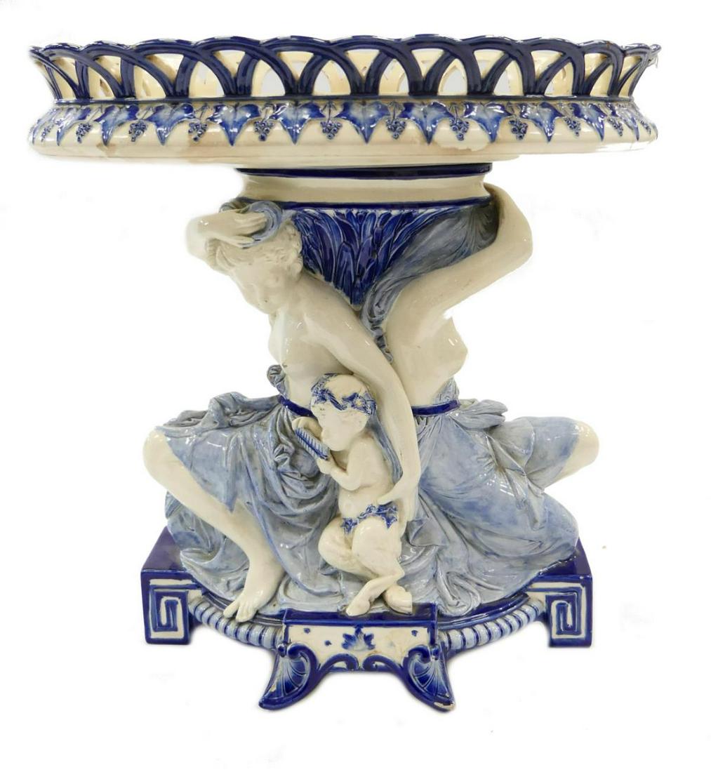 1876 WEDGWOOD BLU & WHITE PORCEALIN COMPOTE: Impressive antique Wedgwood blue and white porcelain centerpiece compote having figural design depicting two nude females with young satyrs. Base with footed design decorated with shells and Greek key