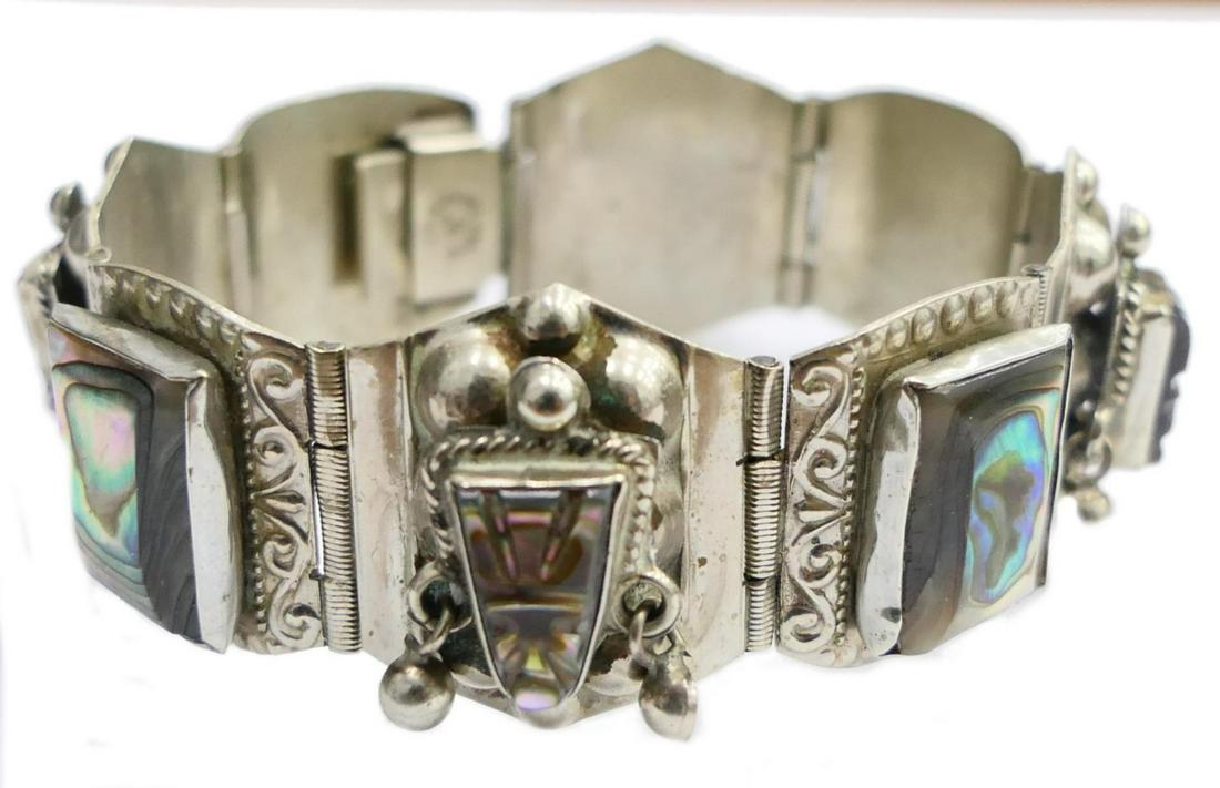 VINTAGE HEAVY STERLING MEXICAN ABALONE BRACELET: Measures 7' long and 1" wide, each link with carved abalone insert. This is a fine and special bracelet, of 46 grams . Third party shipping required