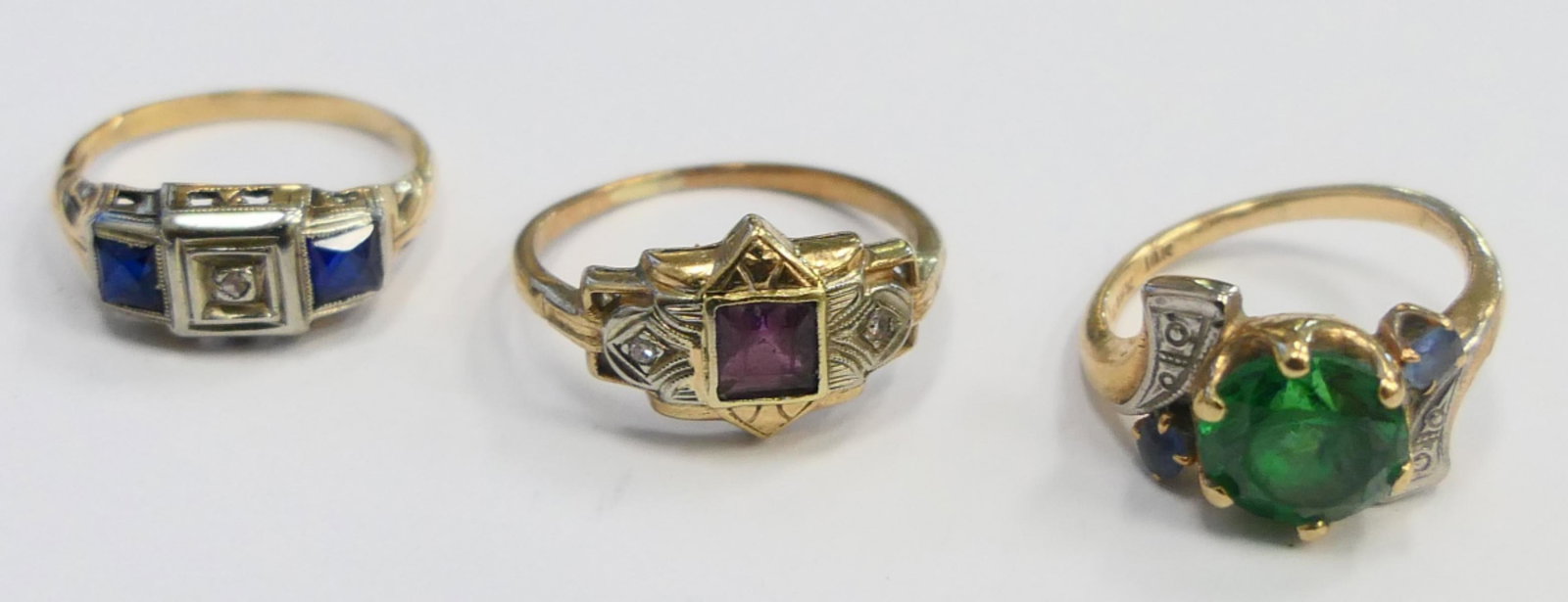 LOT OF (3) ANTIQUE 10KT GOLD RINGS WITH STONES: All are size 4. To inc Emerald, Diamond & Sapphire, and Garnet. Total weight of the 3 rings is 6.2 grams. Third party shipping required