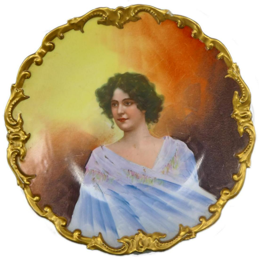 LRL LIMOGES FRENCH PORCELAIN PORTRAIT PLATE: Antique French porcelain portrait plate charger by L. R. L. Limoges depicting a young lady with a blue shawl. Signed "E Veitori" to lower left. Completed with a gilt encrusted scroll scalloped rim. Me