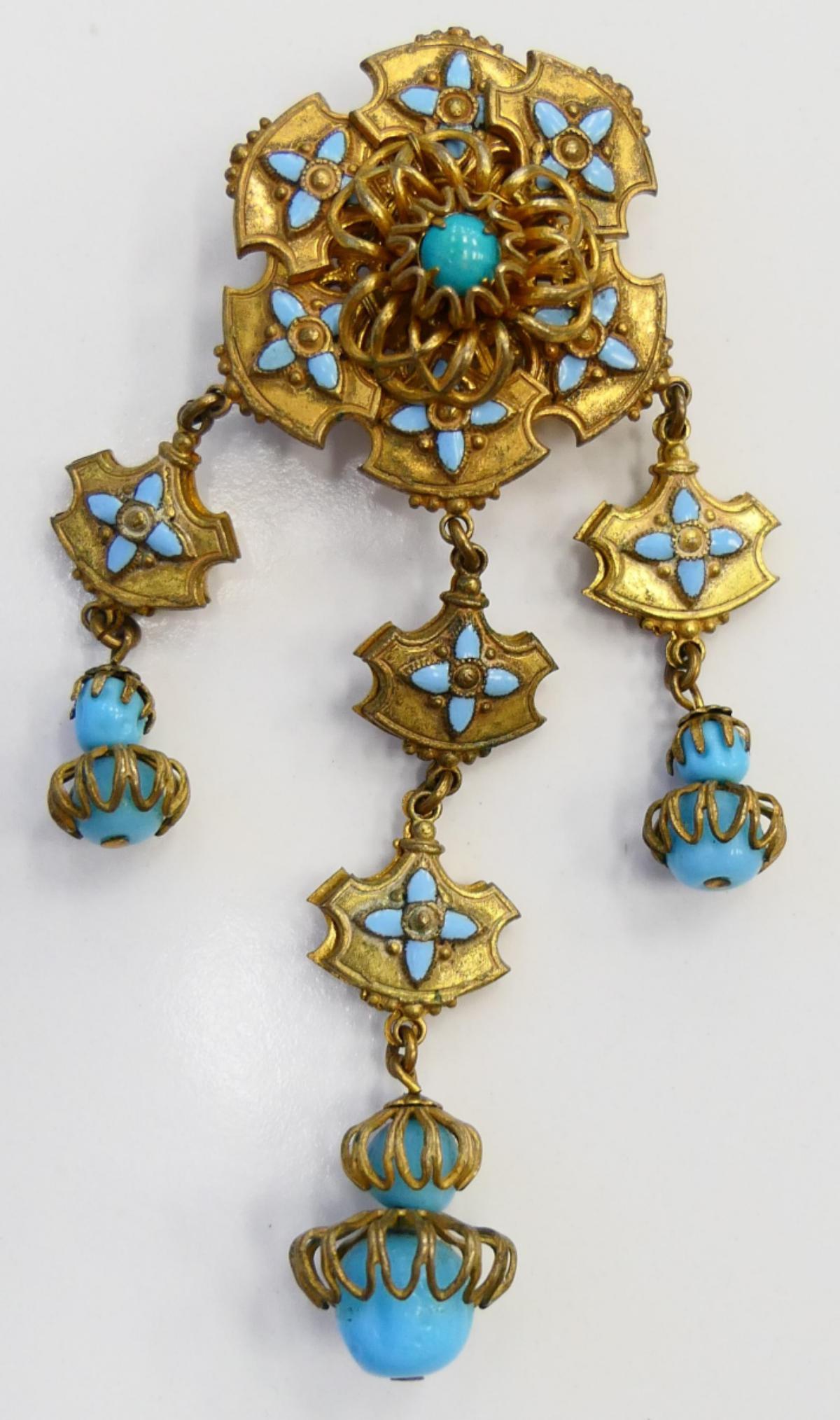 MIRIAM HASKELL VINTAGE GOLD TONE BROOCH: About 3 1/2" long with faux turquoise. Signed Miriam Haskell. Excellent condition. Third party shipping required