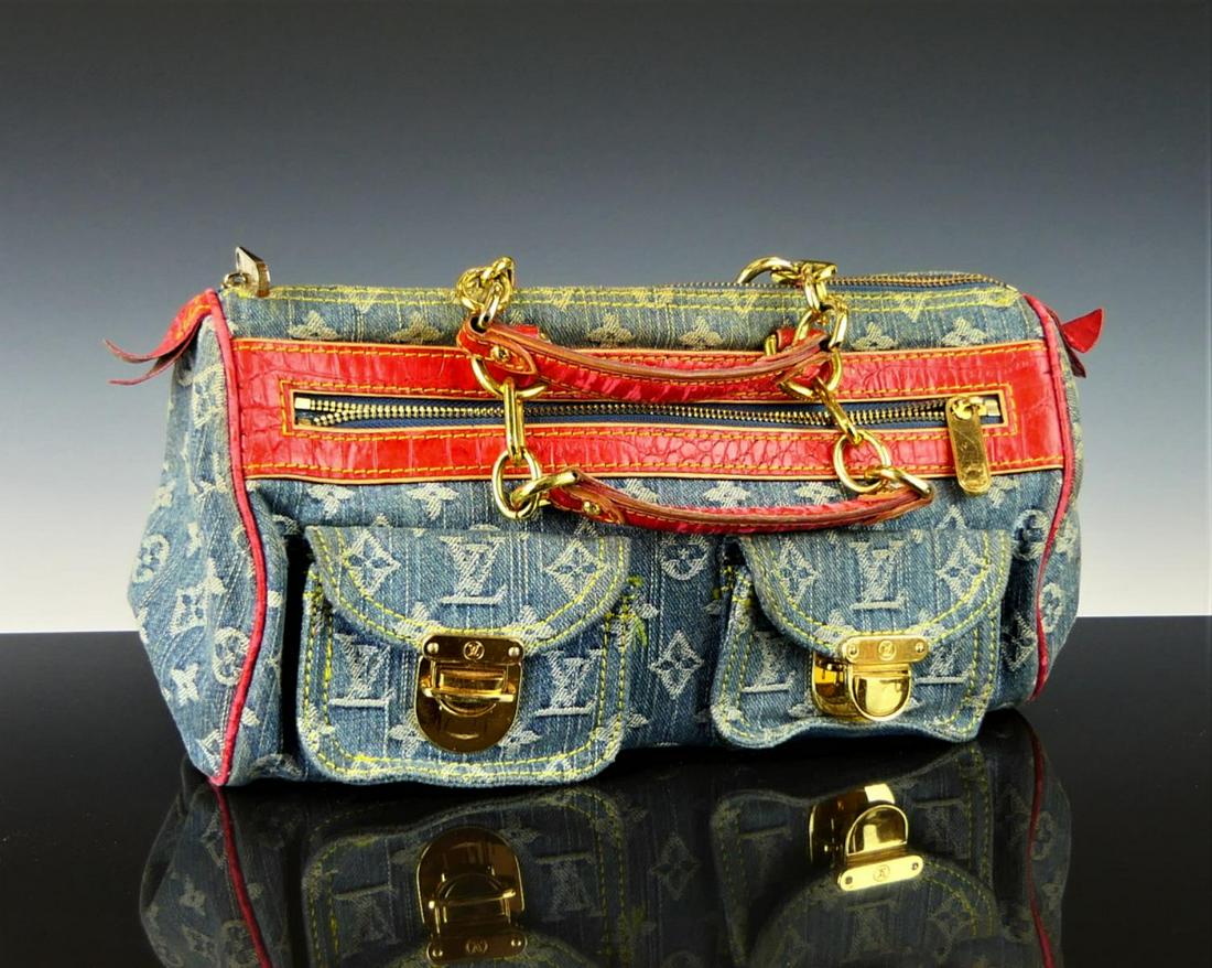 LOUIS VUITTON BLUE DENIM MONOGRAM RED LEATHER PURSE: Louis Vuitton design denim monogram handbag purse with red faux crocodile leather. Gold tone hardware. One zippered exterior pocket with two fold over pockets. Suede interior with one open pocket. Mea