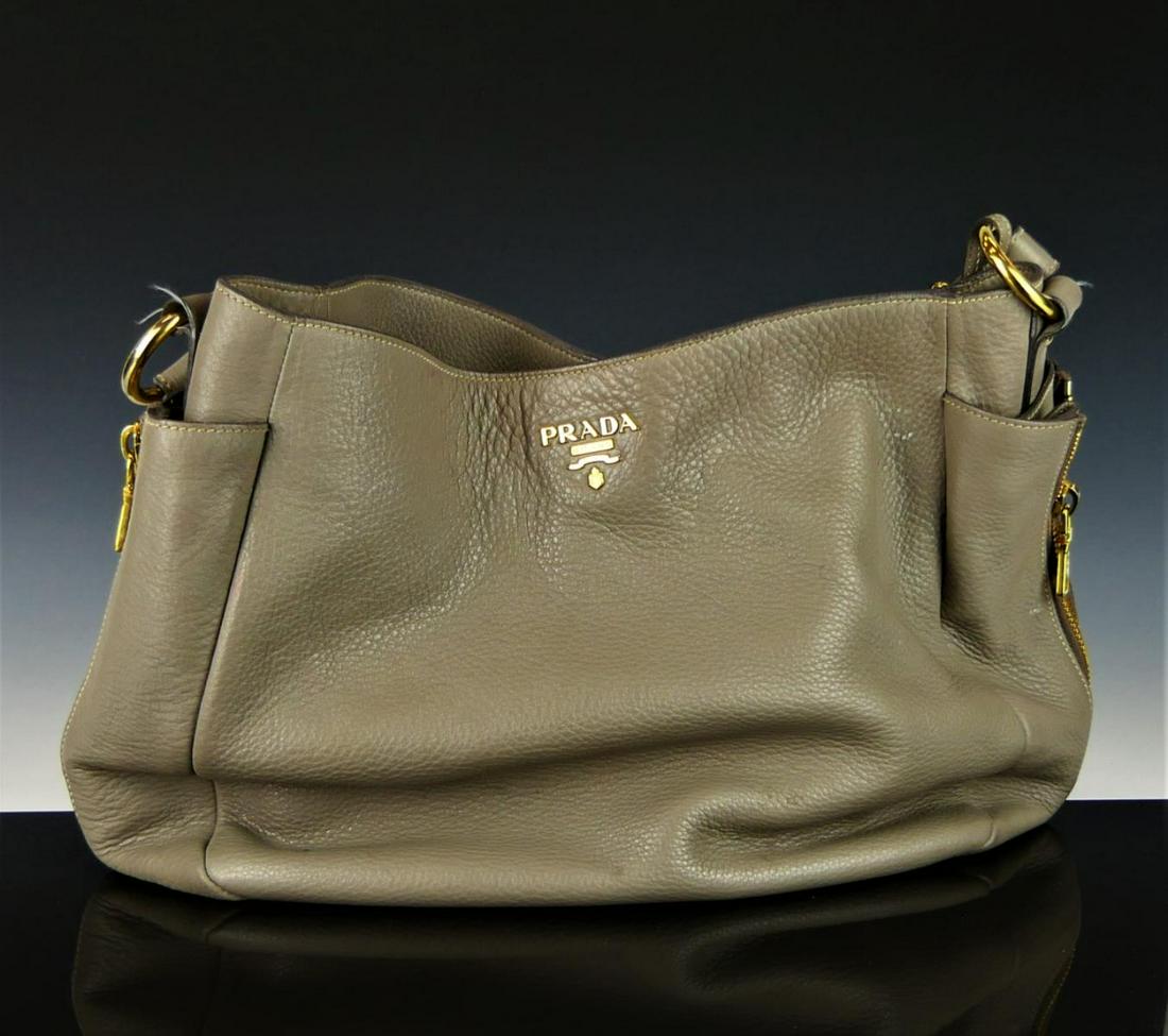 PRADA GRAY PEBBLED LEATHER SHOULDER BAG PURSE: Prada gray pebbled leather shoulder bag purse. Gold tone hardware. Black silk interior with one zippered pocket and one open pocket. Measures approx. 11 1/2" height x 17 1/4" width x 6 1/2" depth (29.