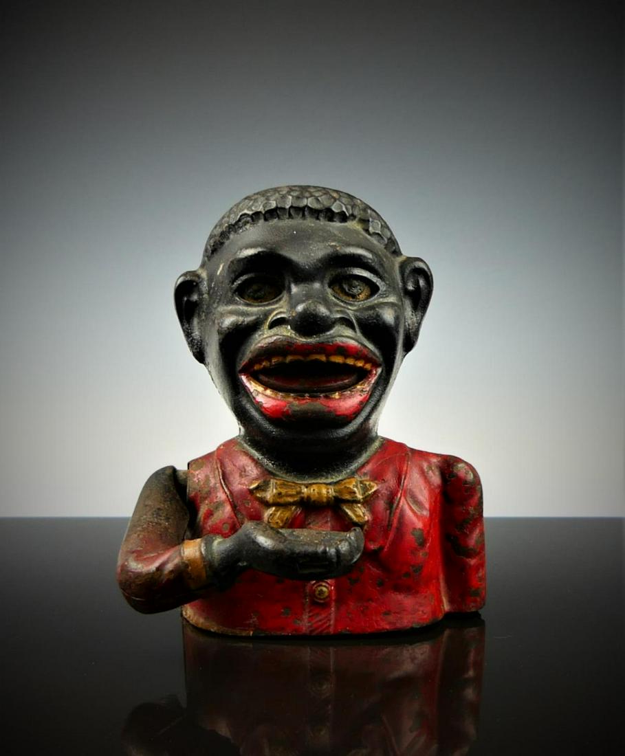 ORIGINAL "BLACK AMERICANA JOLLY" CAST IRON BANK: Measures 6" tall. Original red paint with white bow tie. Seems to be in good working condition. Third party shipping required