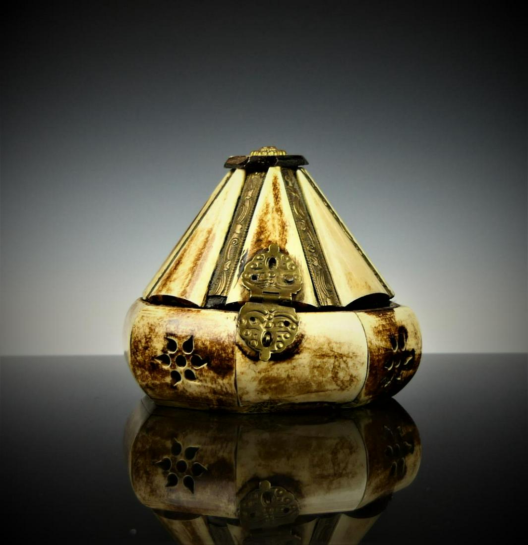 VINTAGE INDIAN BONE INLAID HINGED JEWELRY BOX: Vintage Indian hinged jewelry trinket box crafted of bone and brass. Side of base with reticulated floral designs. Measures approx. 3 1/2" height x 4 1/2" diameter (8.9cm x 11.4cm).