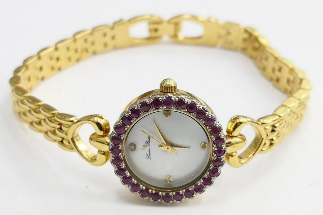 LUCIEN PICCARD RUBY SET STAINLESS WATCH: From a local estate. This watch is marked to back. Original gold plated band. Gold hands on white porcelain dial. Third party shipping required .