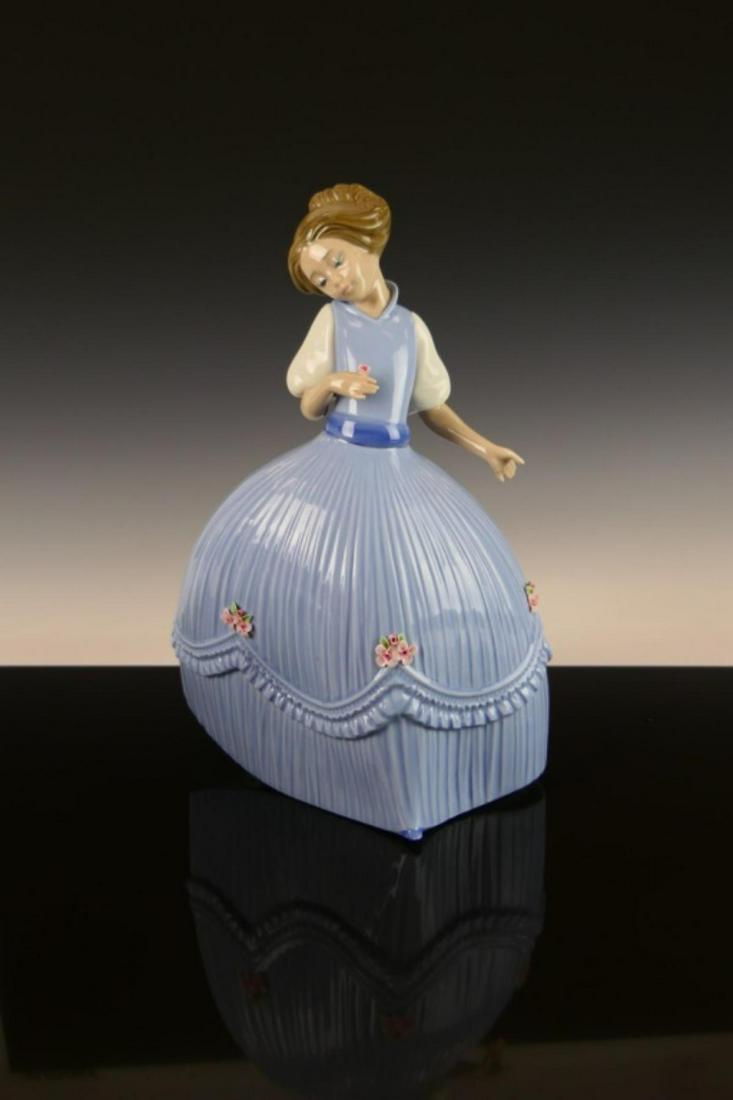 LLADRO PORCELAIN FIGURE GIRL IN BLUISH DRESS 5119: Lladrp Spanish glazed porcelain figure depicting a girl with flower titled "Girl in Bluish Dress" or "Primavera No.2" number 5119. Sculpted by José Puche. Issued in 1982 and retired in 1985. Measures