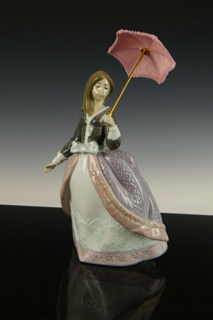 LLADRO SPANISH PORCELAIN FIGURE "ANGELA" #5211: Lladro Spanish glazed porcelain figure depicting a girl with parasol titled "Angela" or "Damisela Sombrilla En Alto" number 5211. Sculpted by José Puche. Issued in 1984 and retired in 2002. Measures 