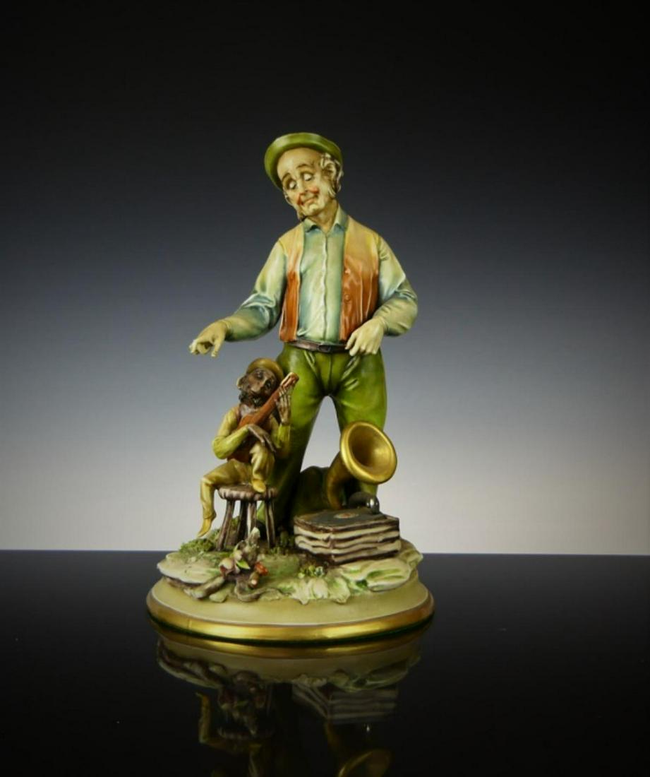ANTONIO BORSATO PORCELAIN FIGURINE ORGAN GRINDER: The organ grinder and his monkey, by Antonio Borsato about 8" tall. third party shipping is required